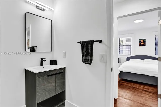 a en suite bathroom with a sink vanity and mirror