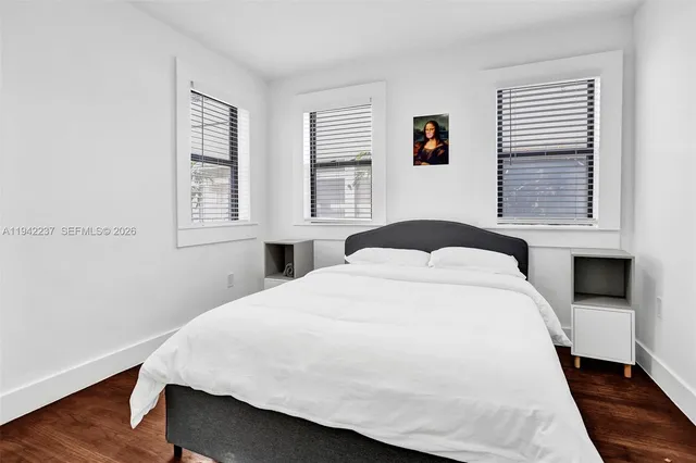 a bedroom with a large bed and a window