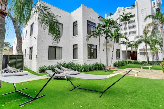 a view of a house with backyard porch and sitting area