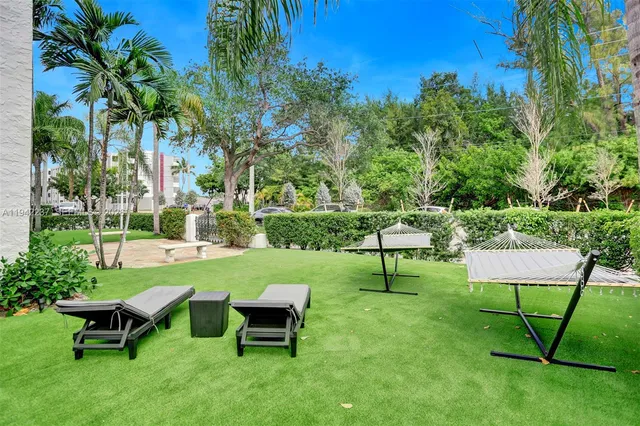 a view of a garden with a bench and some plants