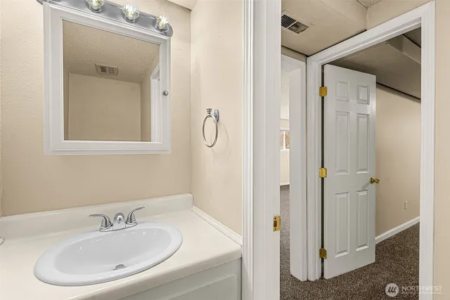 a bathroom with a sink and mirror
