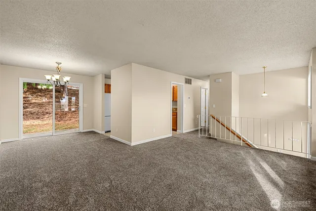 an empty room with a empty space and windows