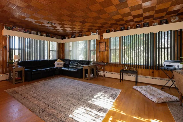 a living room with furniture rug and wooden floor