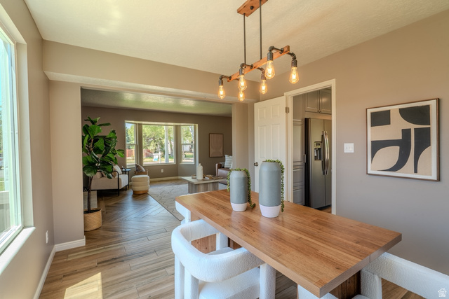 11957 Noelle Road Sandy, UT 84092 - Photo 10 of 38 Dining area featuring a wood-finish countertop and industrial-style pendant lighting