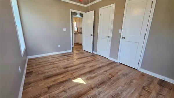 a view of a hallway with wooden floor