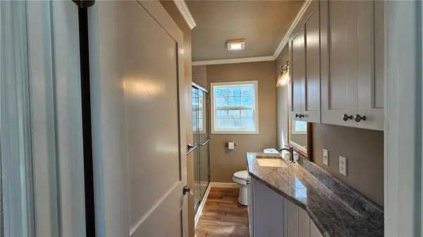 a bathroom with double vanity and a mirror