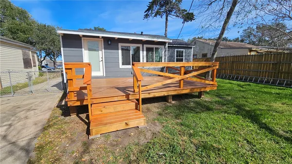 a view of a house with backyard and sitting area