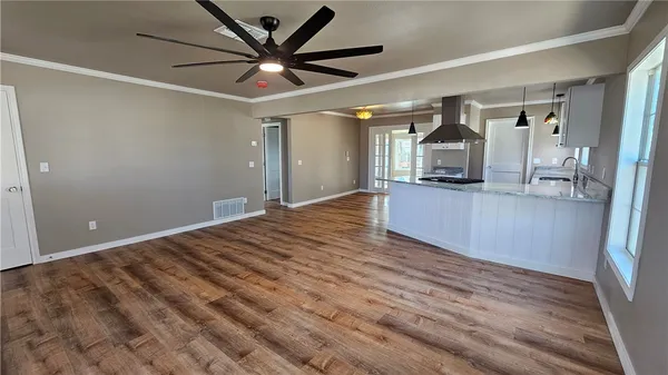 a view of a kitchen with a sink and a ceiling fan