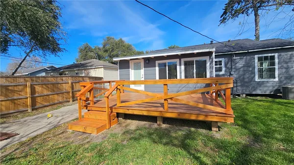 a view of a house with backyard sitting area and tub