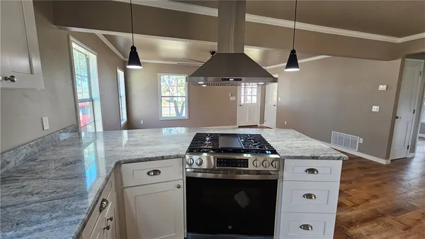 a kitchen with a stove and a refrigerator