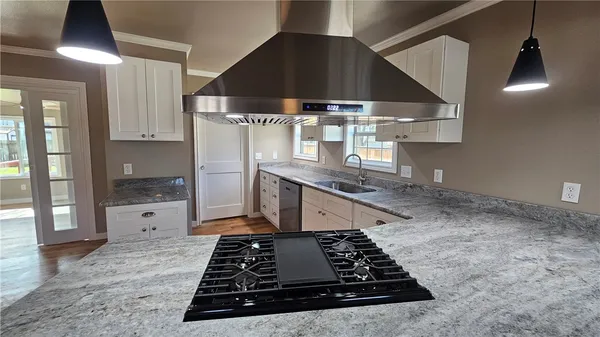 a kitchen with kitchen island a counter space a stove and a refrigerator