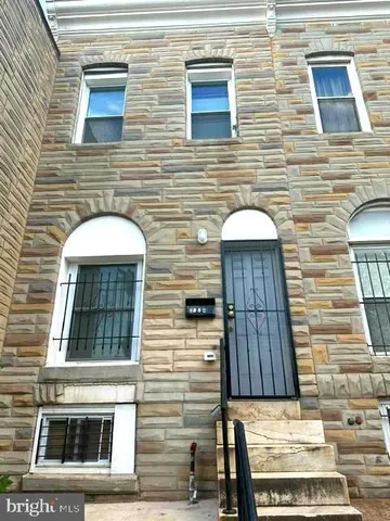 a view of a brick house with many windows