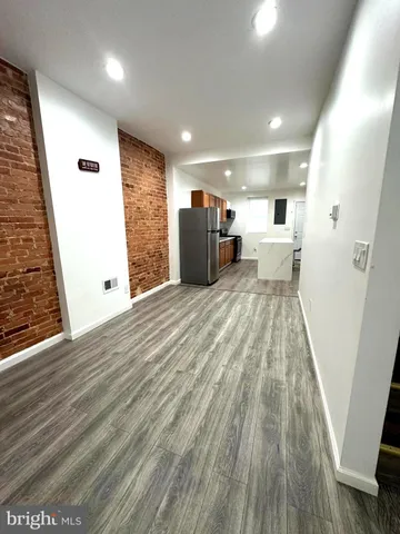 a view of a room with wooden floor and windows