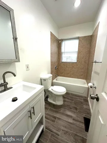 a bathroom with a sink a toilet and mirror