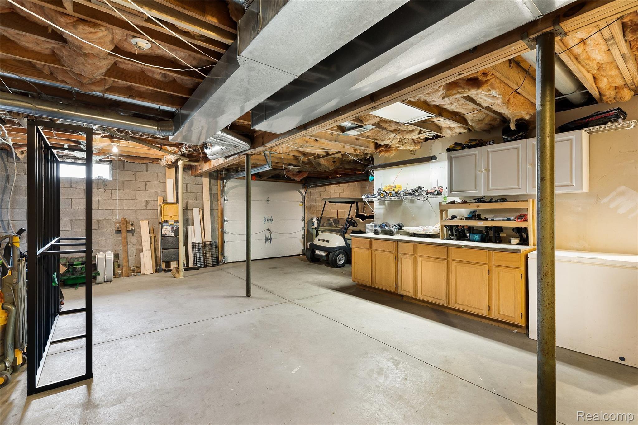 13895 Hibner Road Hartland, MI 48353 - Photo 40 of 43 Walkout basement, currently used with overhead door