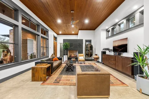 a view of a house with a yard and a large tree