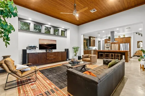 a kitchen with a stove a counter top space furniture and a fireplace