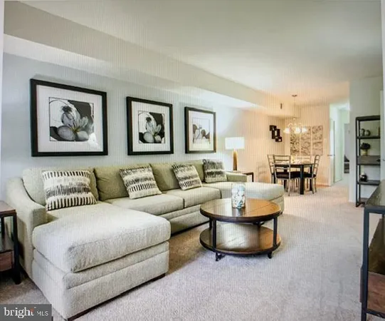 a living room with furniture and a painting