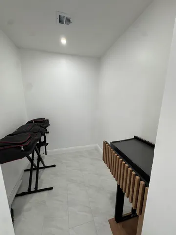 a view of an empty room and wooden floor