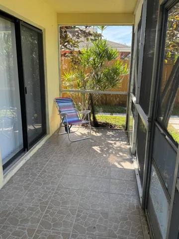a view of two chairs in the balcony