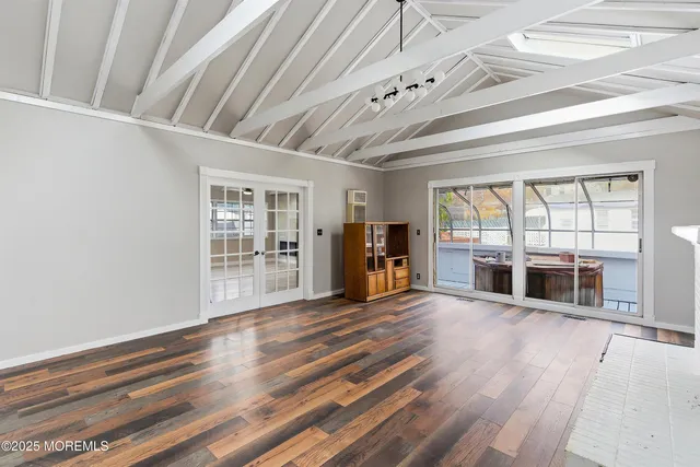 wooden floor in an empty room with wooden floor and a window