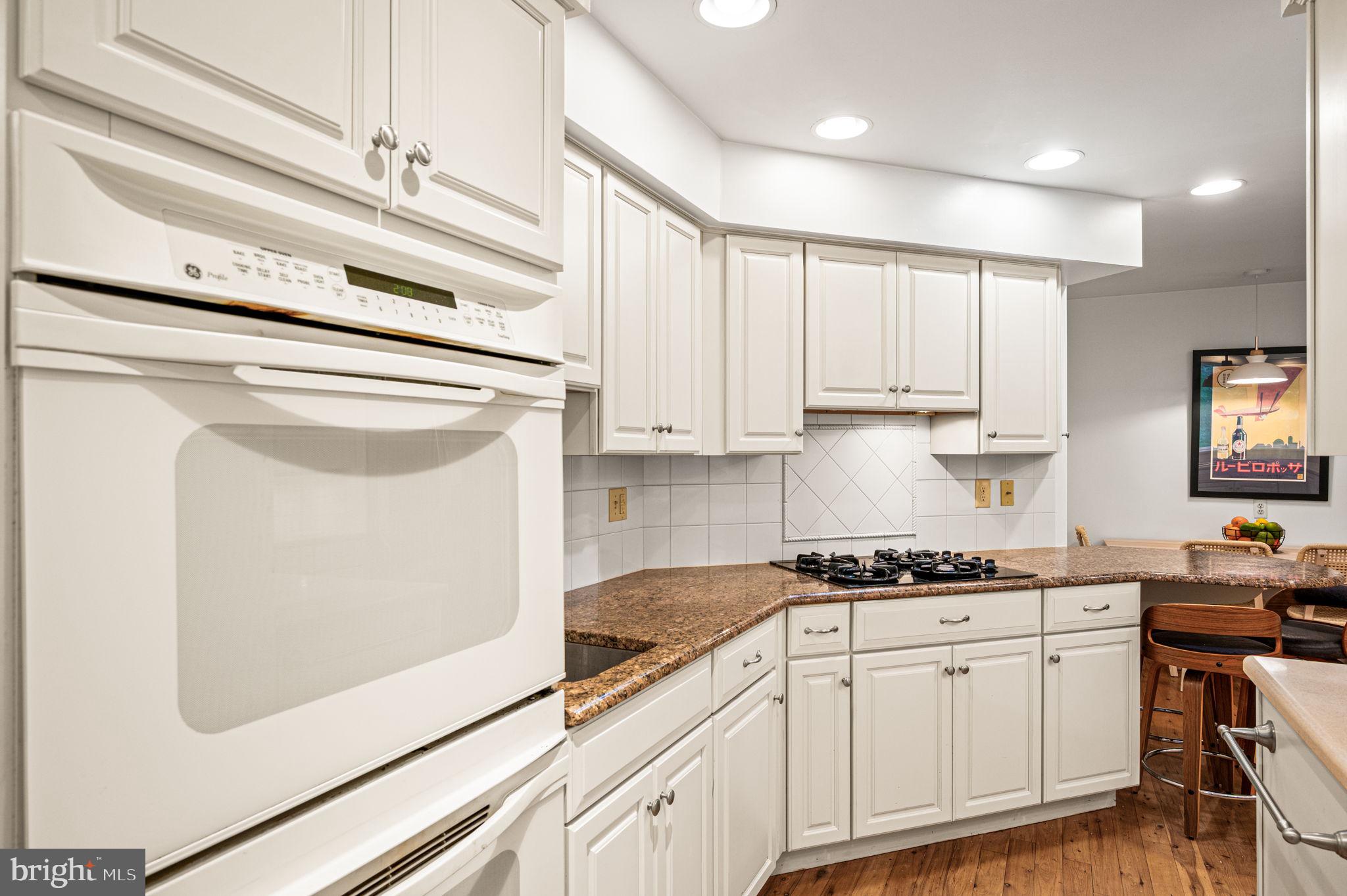 434 Pugh Road Wayne, PA 19087 - Photo 20 of 47 a kitchen with granite countertop white cabinets and white appliances
