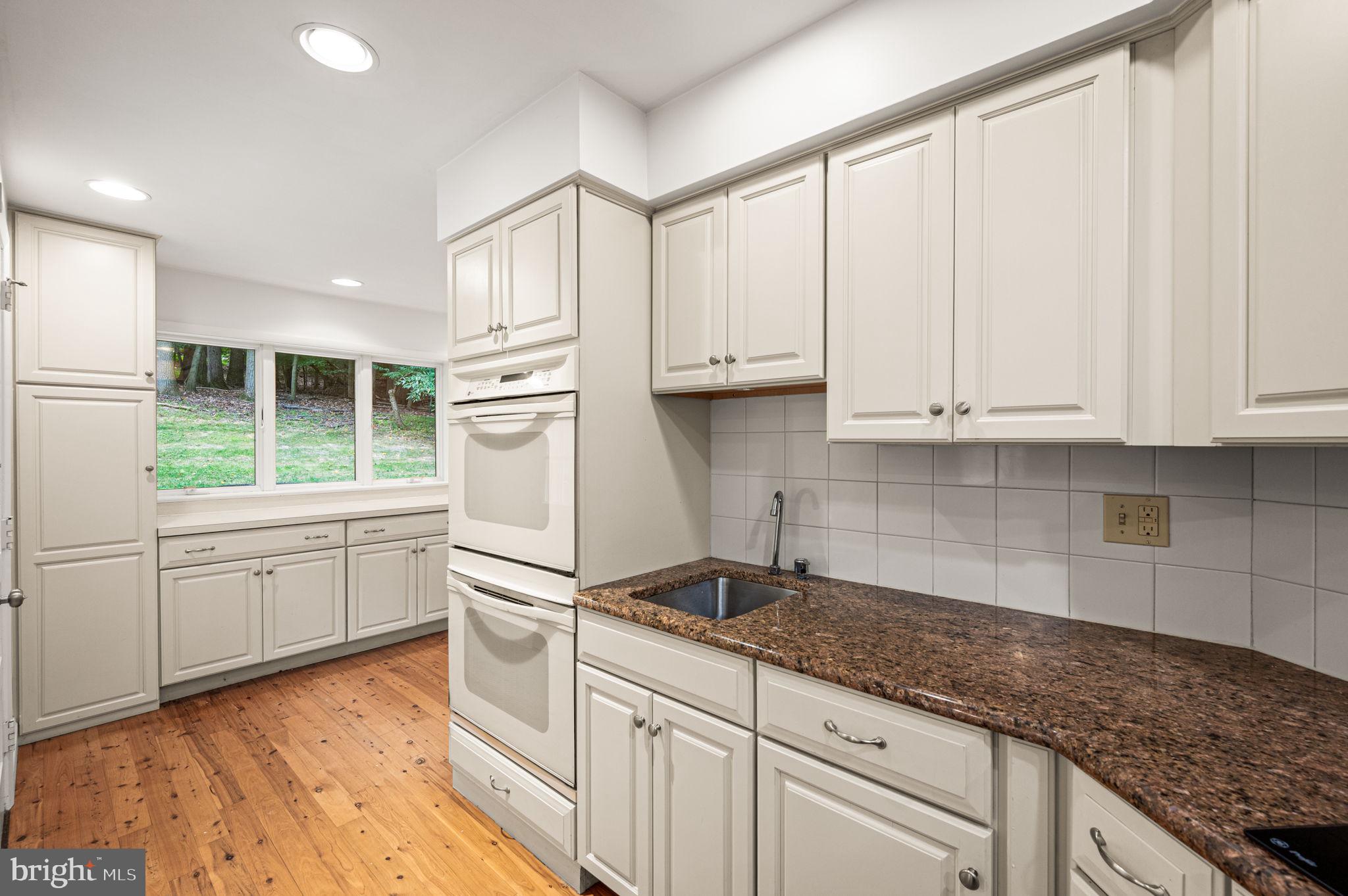 434 Pugh Road Wayne, PA 19087 - Photo 21 of 47 a kitchen with granite countertop white cabinets and white appliances