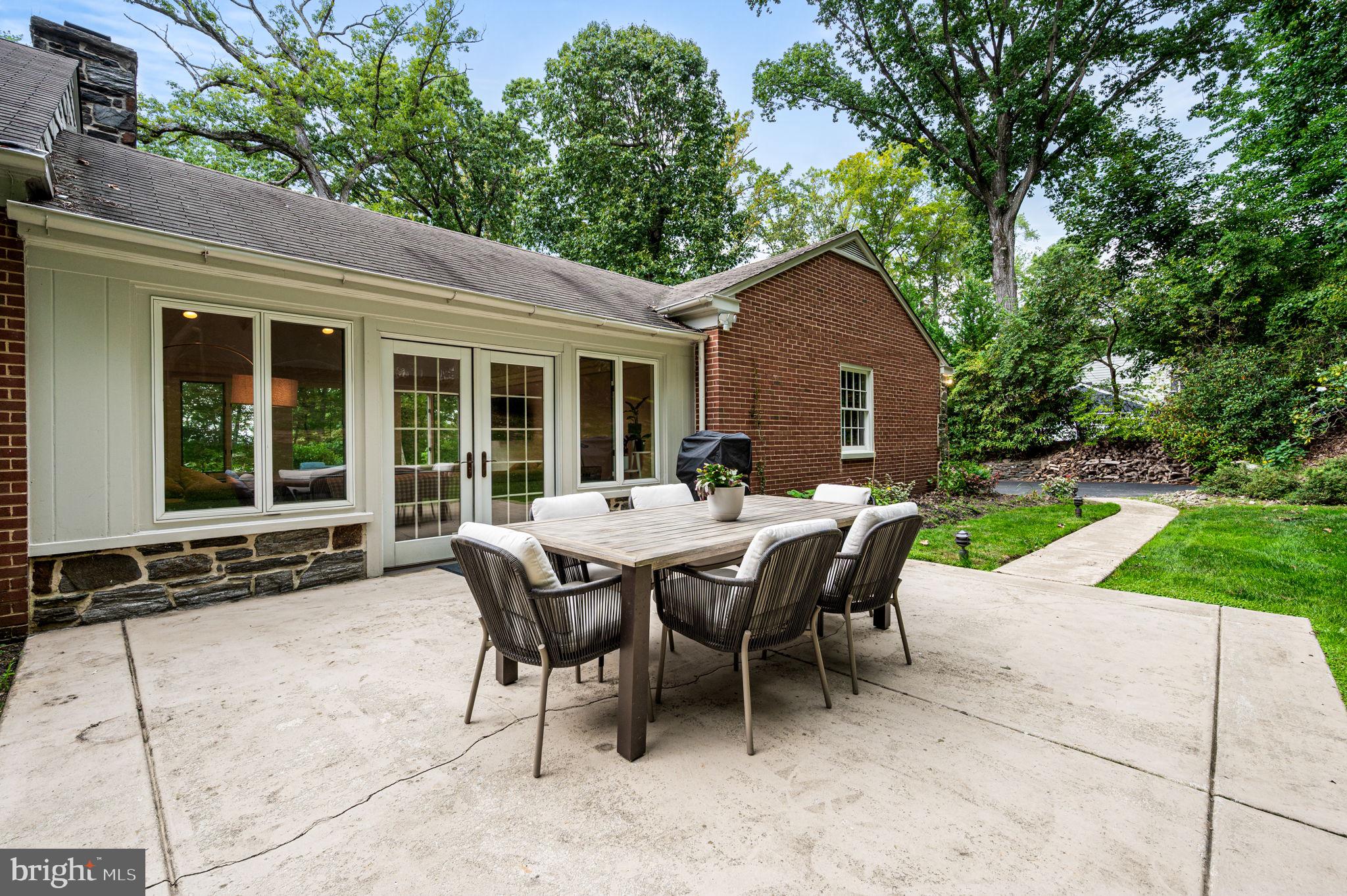 434 Pugh Road Wayne, PA 19087 - Photo 25 of 47 a patio with a table and chairs and potted plants