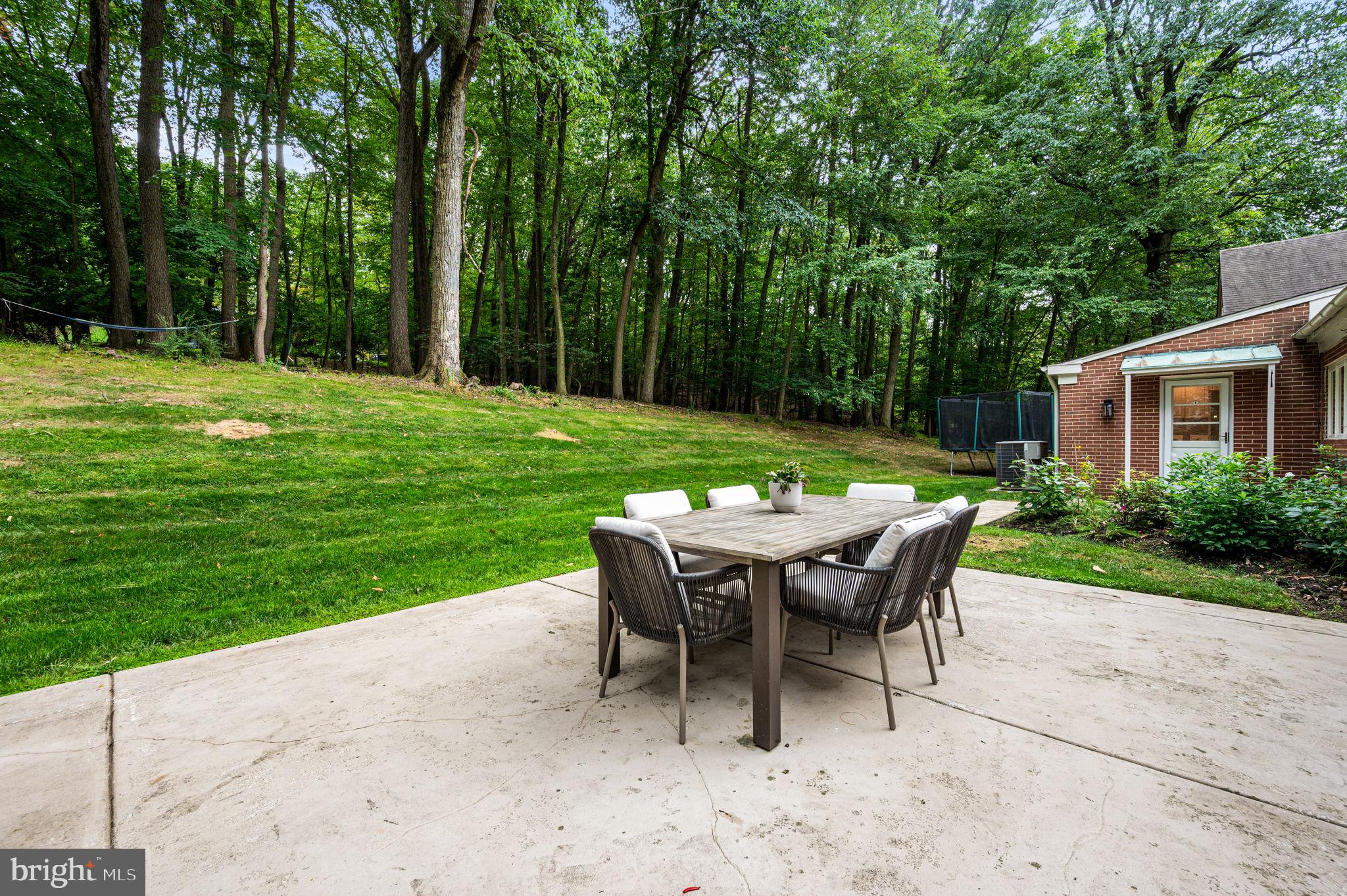 434 Pugh Road Wayne, PA 19087 - Photo 26 of 47 a view of a dining table and chairs in the garden