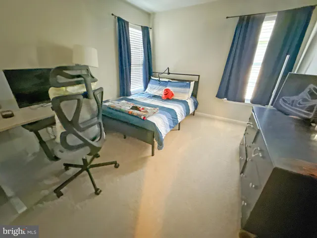 a bedroom with a bed and chair