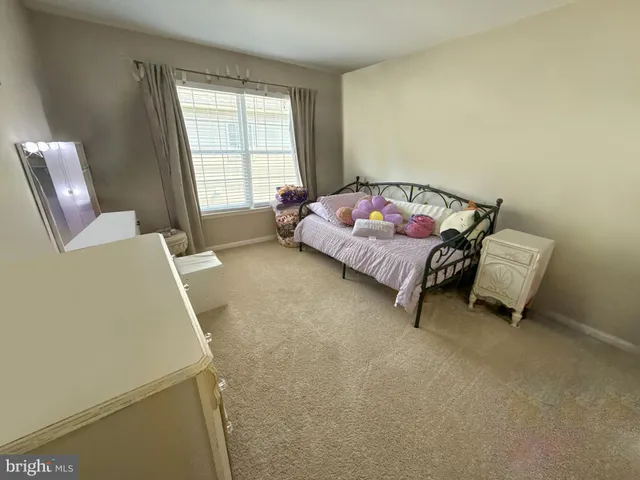 a bed room with a bed and a chair