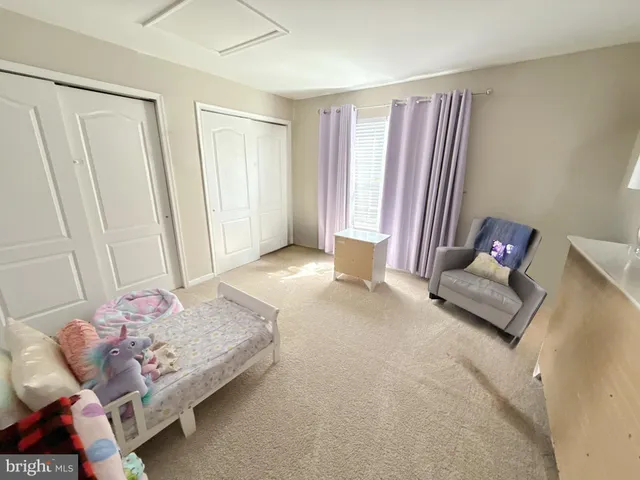 a bedroom with a bed and couch