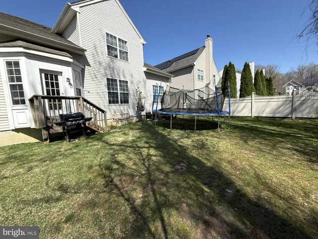 a view of a house with a yard patio and a slide