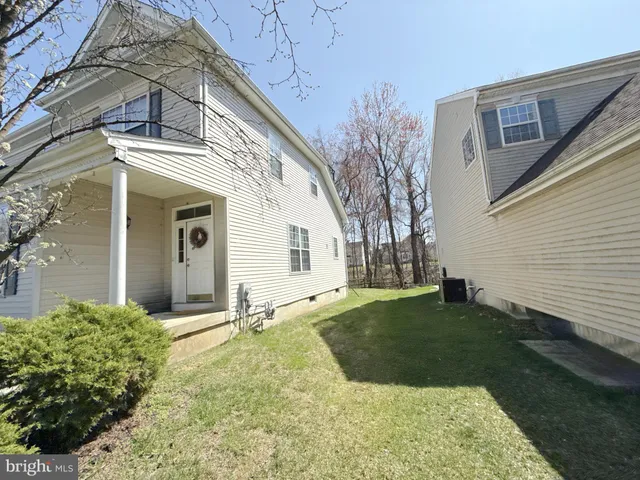 a view of a white house with a yard