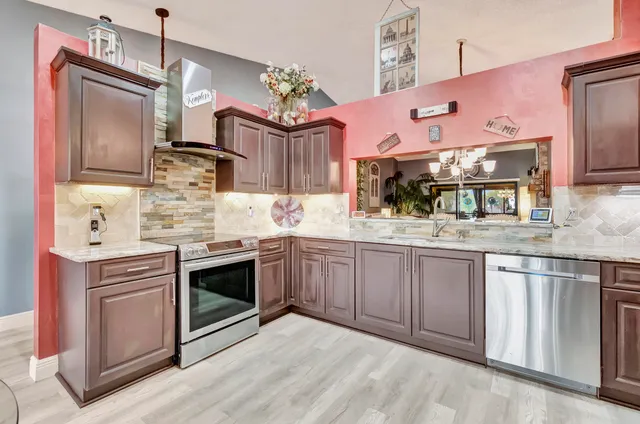 a kitchen with a sink stove and microwave