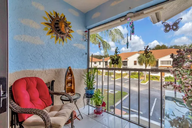 a view of swimming pool with a potted plant and outdoor seating
