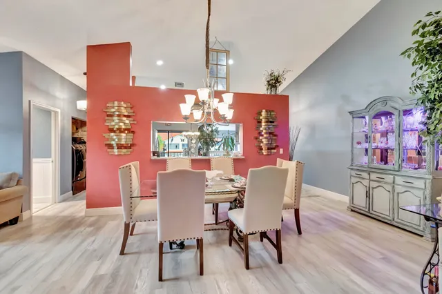 a dining room with furniture and wooden floor