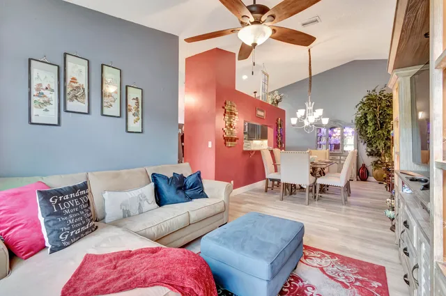 a living room with furniture and a chandelier