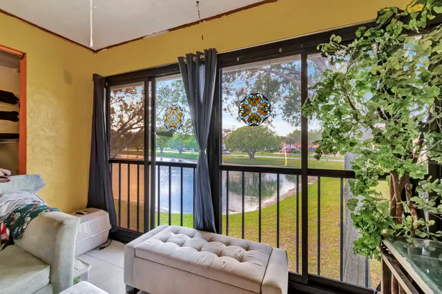 a bedroom with furniture and large windows