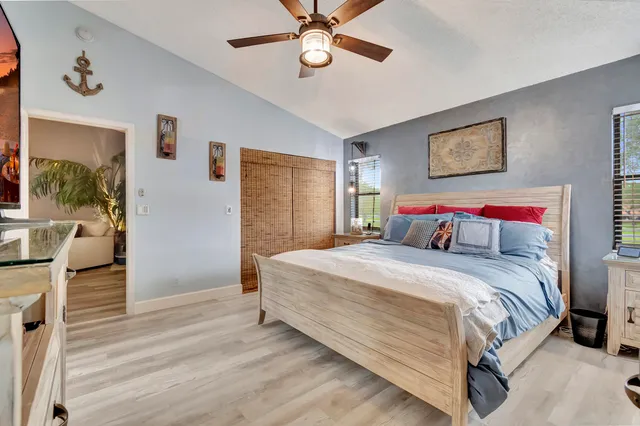 a bedroom with bed and a chandelier