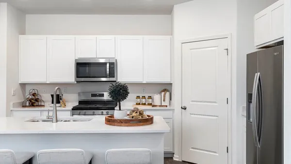 a kitchen with stainless steel appliances a refrigerator a stove a microwave and cabinets