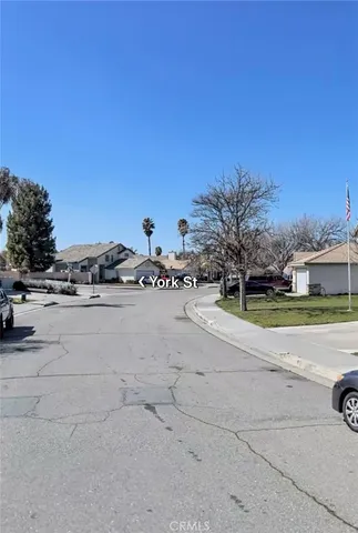 a view of white house with a yard and ocean view