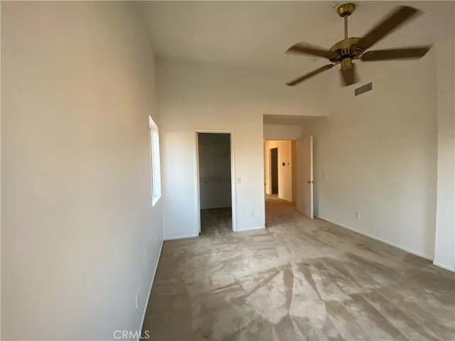 a view of a room with a ceiling fan