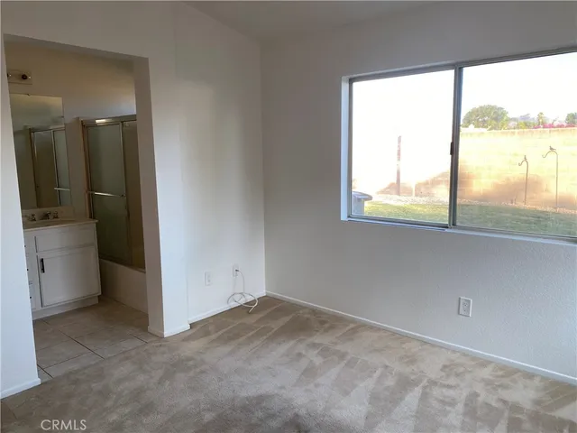 an empty room that has a large window