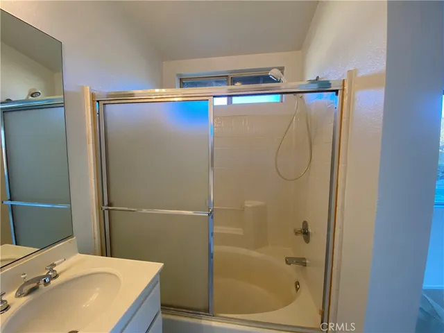 a bathroom with a shower and a sink
