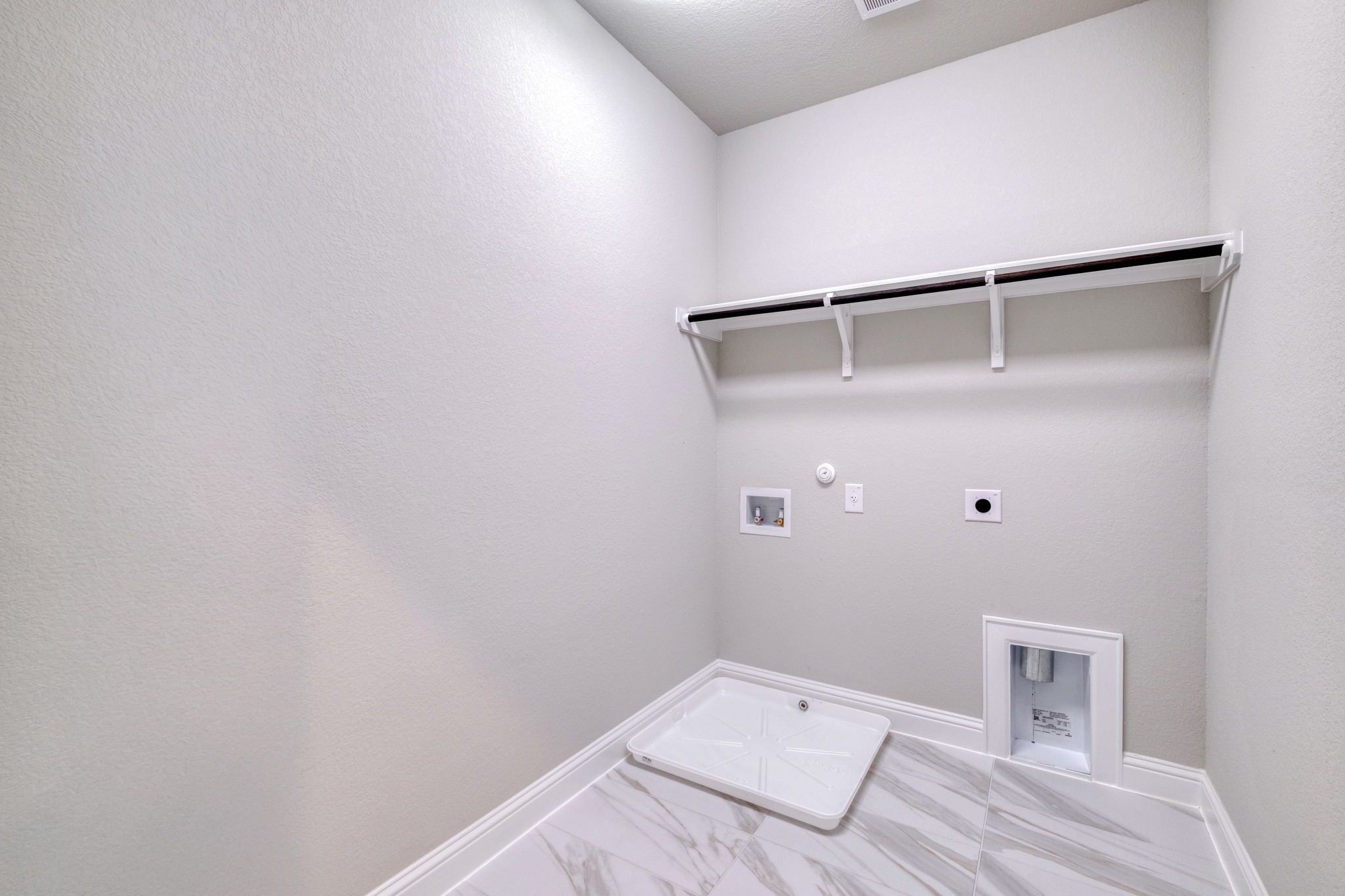 2605 Sam Bass Road, Unit 44 Round Rock, TX 78681 - Photo 23 of 26 A dedicated utility space with durable tile flooring and convenient laundry hookups awaits customization.