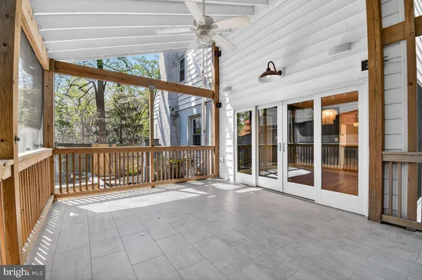 en empty room with stairs and large windows