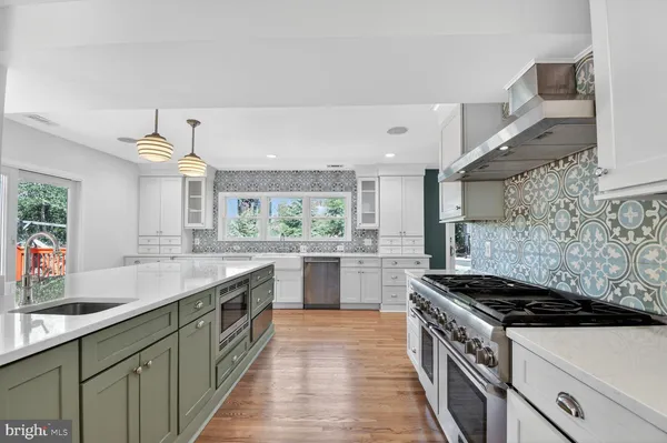 a kitchen with stainless steel appliances a sink stove and cabinets