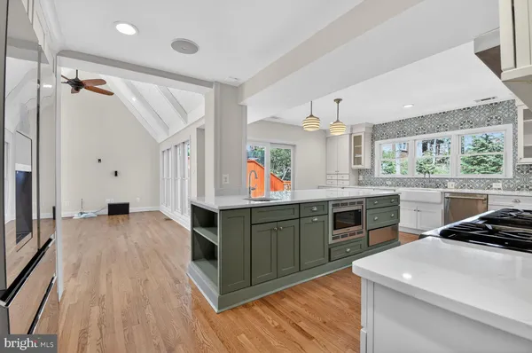 a kitchen with a stove a sink and a refrigerator
