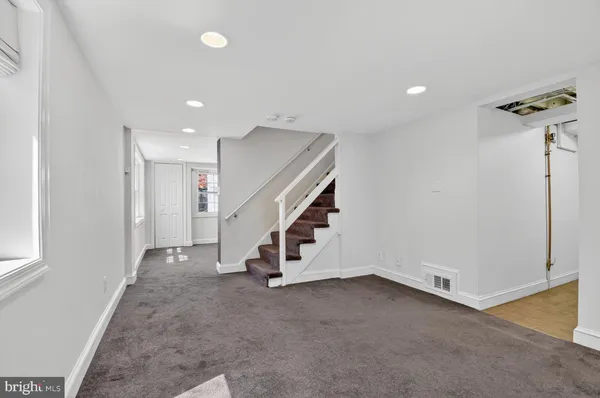 a view of an empty room with stairs